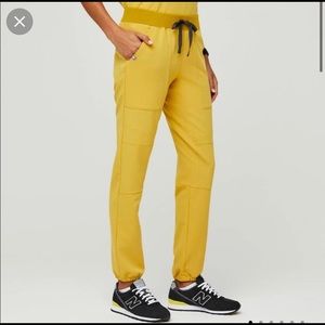 Figs scrubs , never been worn , in size XS gold jogger